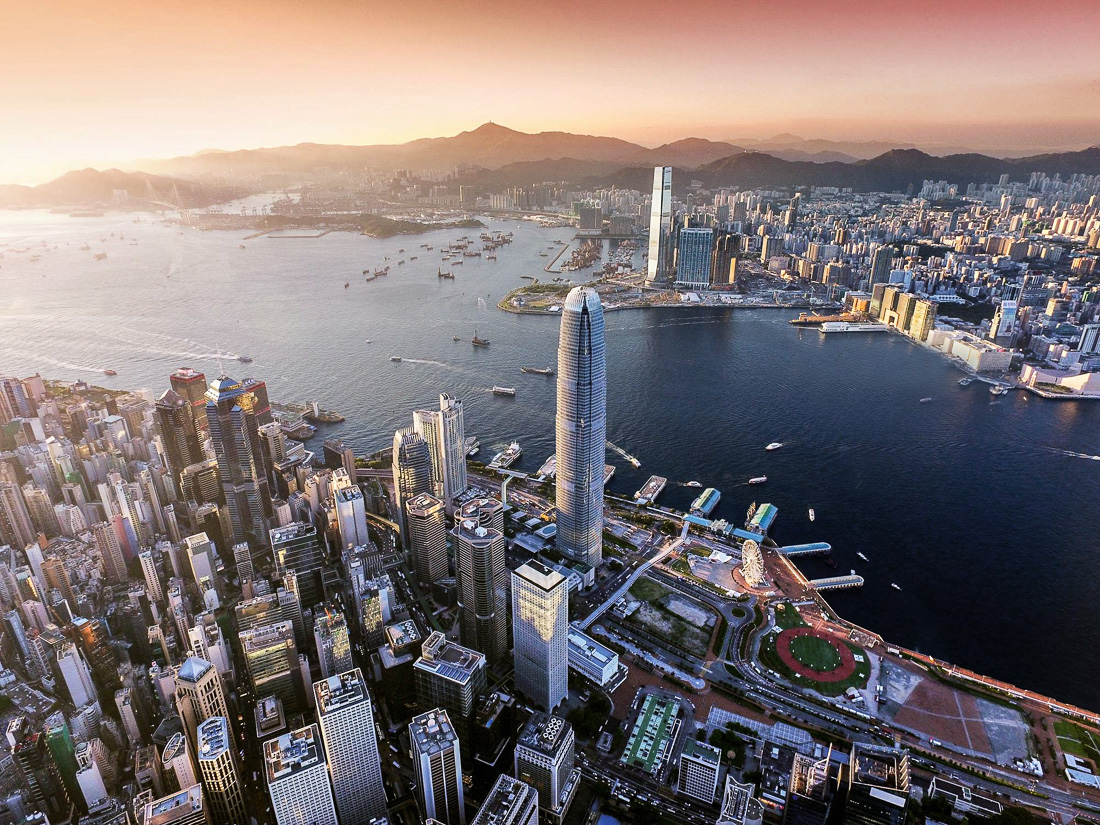 Aerial view of Hong Kong city, Victoria harbour in sunset