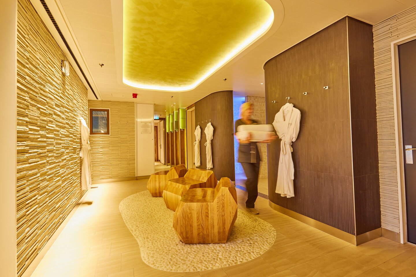 Umkleide- und Ruhebereich im Ocean Spa mit Liegen, Bademänteln und warmem Lichtdesign